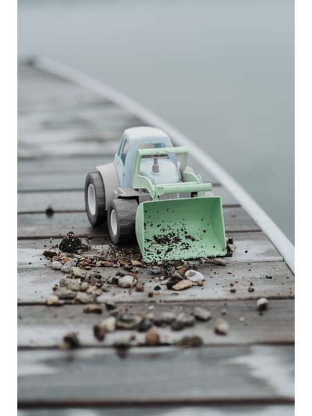 Grå og grøn traktor med frontlæsser, store hjul og førerhus.