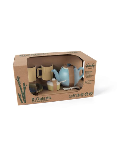 Lyseblåt og brunt te-sæt til børn i gennemsigtig æske med brun karton baggrund