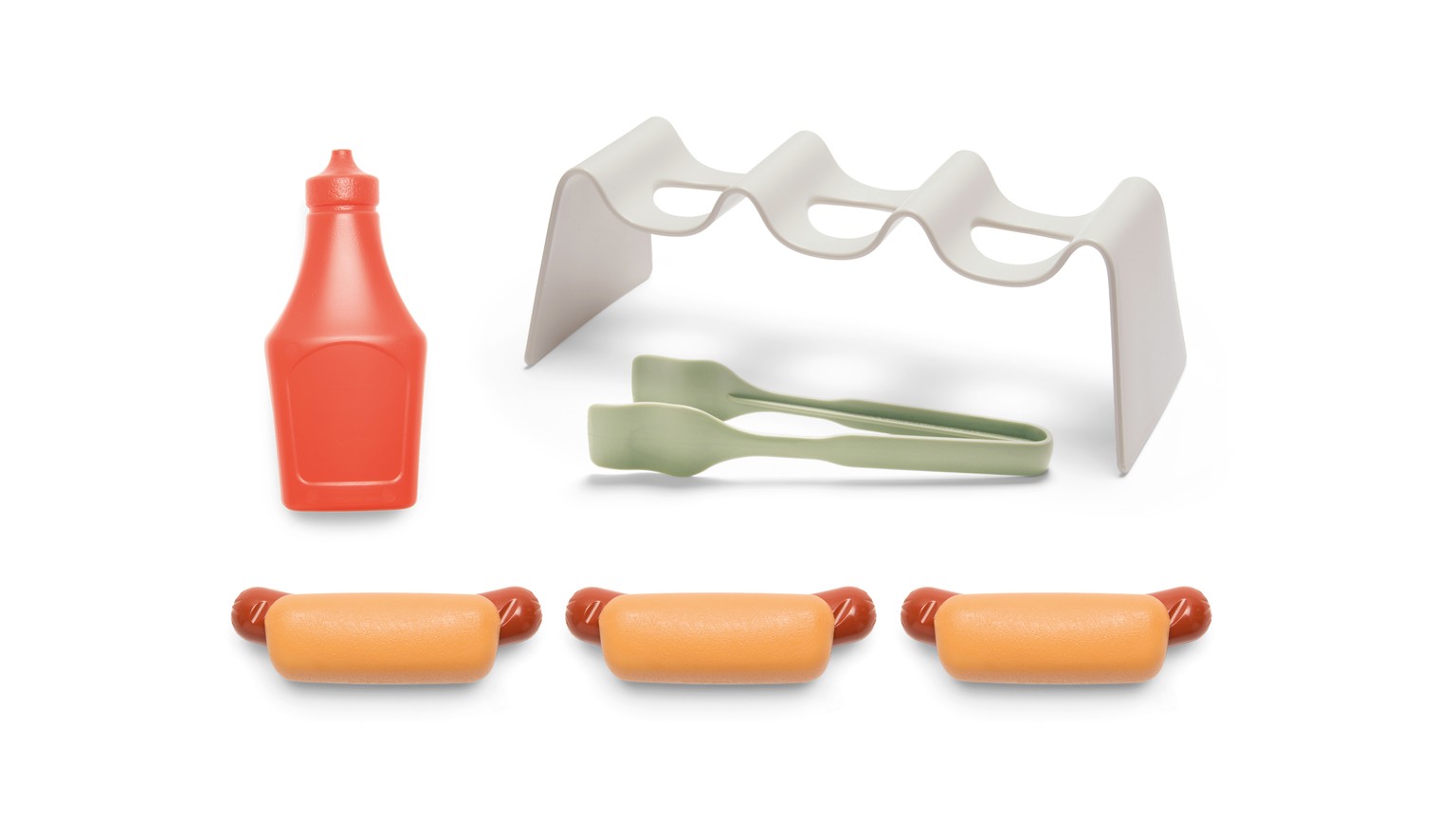 Orange dispenser, sølvfarvet brødholder og tre orange pølsebrød til legemad.